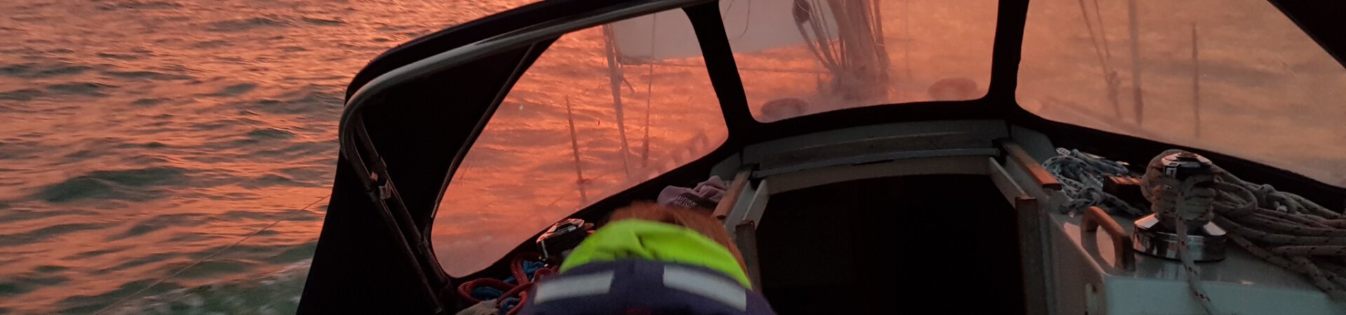 Sailing boat at sea with sunset