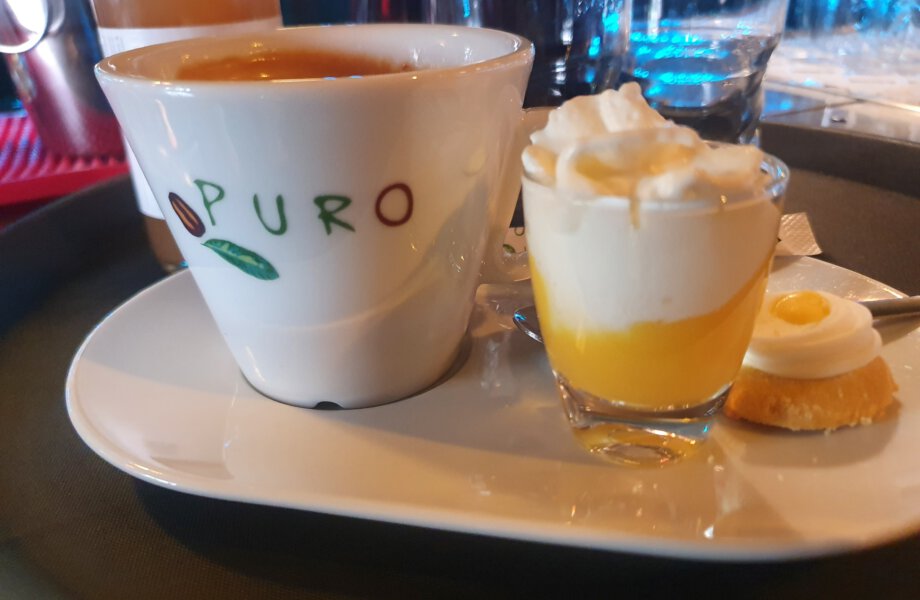 Hot drink on a tray with liqueur and whipped cream