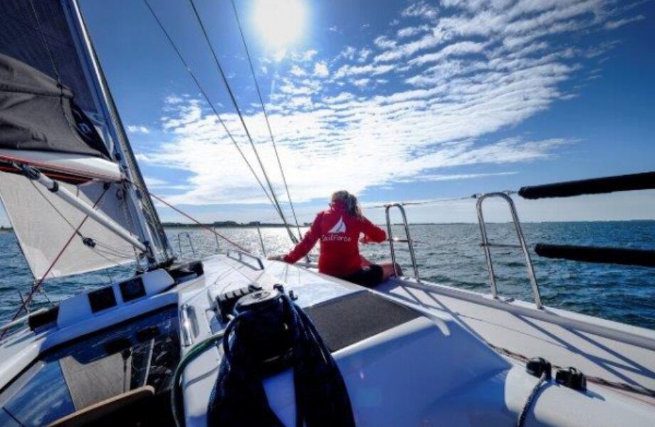 Sailing boat at sea with person on deck